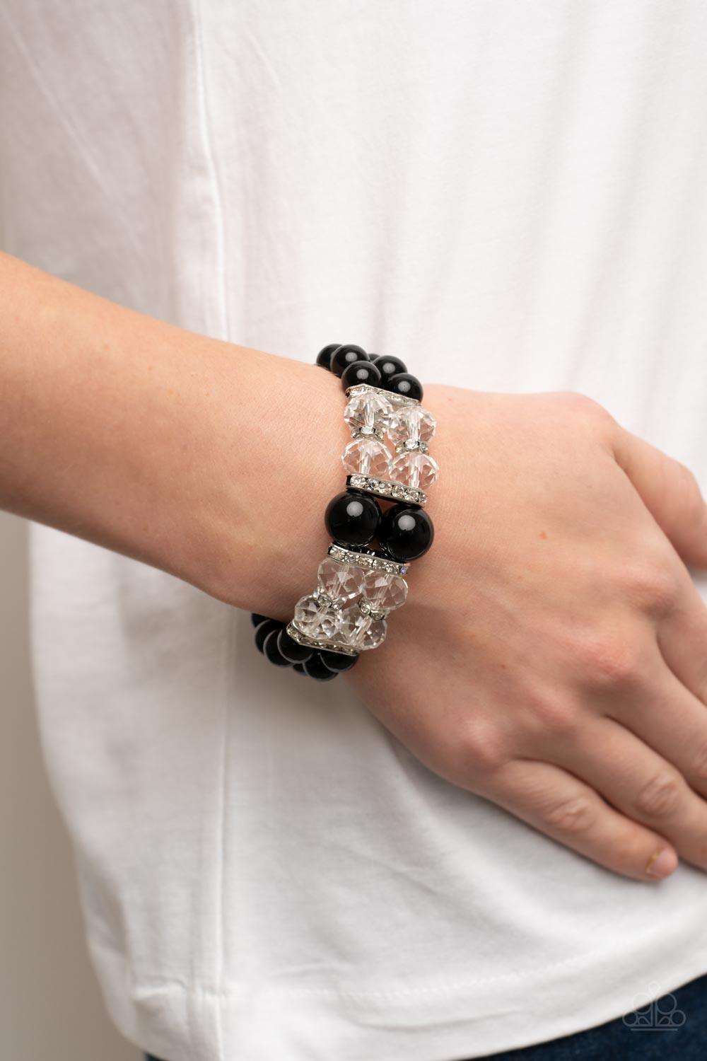 Paparazzi Accessories Timelessly Tea Party - Black Held together by white rhinestone encrusted silver frames, a stretchy pair of bubbly black beaded bracelets are infused with white rhinestone encrusted silver rings, iridescent crystal-like beads, and ove