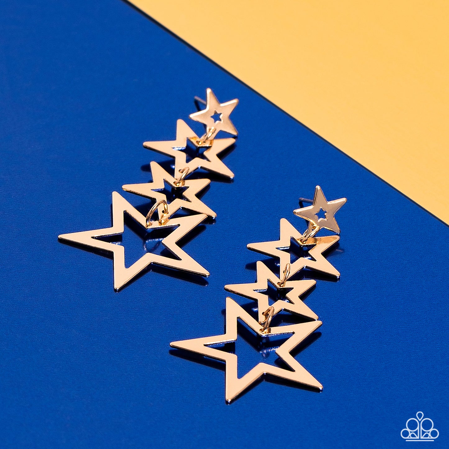 Paparazzi Accessories Superstar Crescendo - Gold Flat gold star frames gradually increase in size as they delicately link into a stellar tassel, resulting in an out-of-this-world fashion. Earring attaches to a standard post fitting. Sold as one pair of po