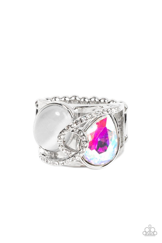Paparazzi Accessories SELFIE-Indulgence - Multi A white rhinestone dotted silver ribbon loops and slants over a tilted white cat's eye stone and iridescent teardrop gem, culminating into a stellar centerpiece. Features a stretchy band for a flexible fit.
