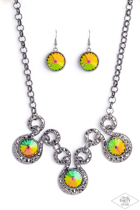 Paparazzi Accessories Hypnotized - Multi Three dramatically oversized oil spill rhinestones are nestled into three textured gunmetal fittings that are connected by oval gunmetal rings, creating a brilliant statement piece. Features an adjustable clasp clo