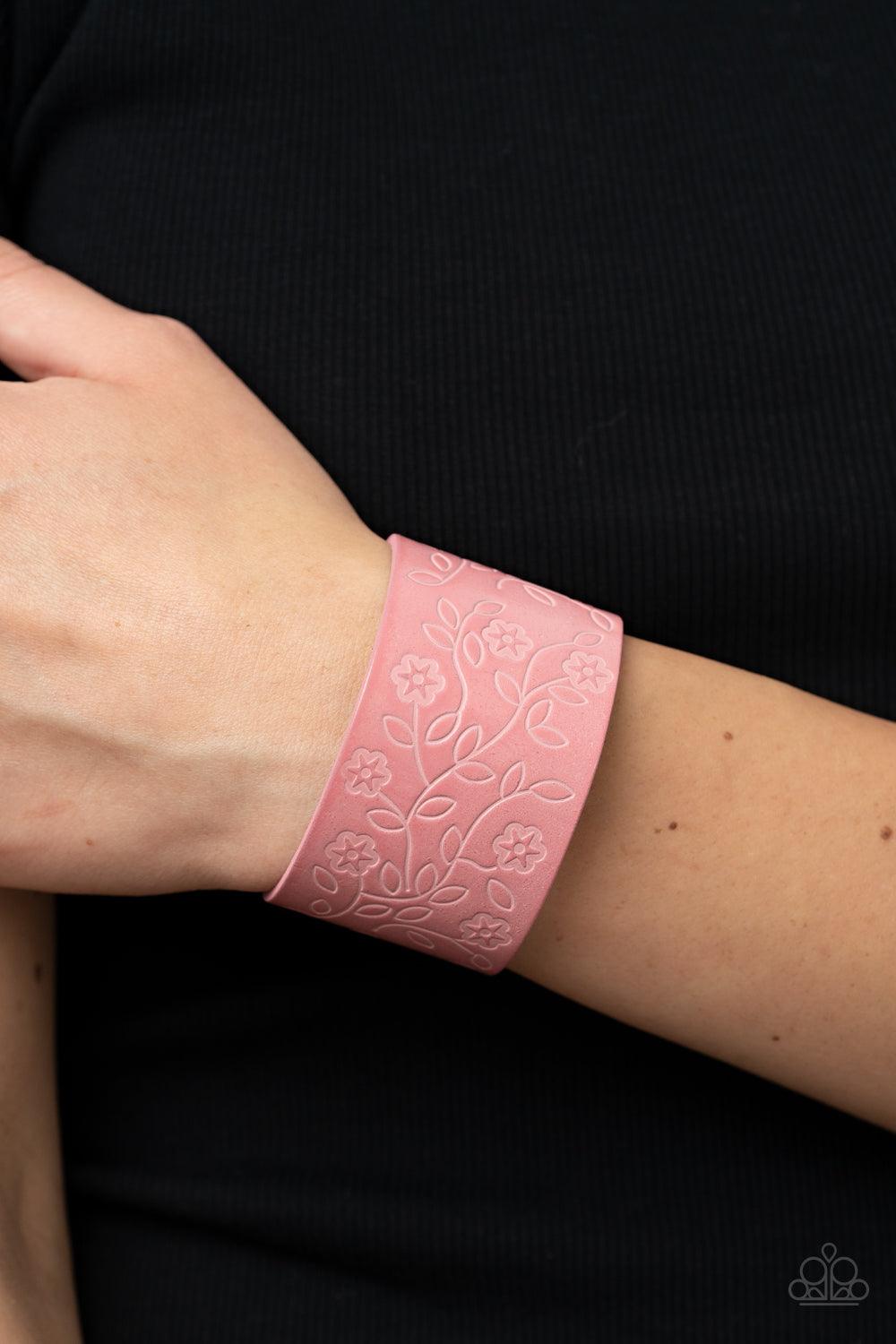 Paparazzi Accessories Rosy Wrap Up - Pink A flowery and leafy motif blooms across the front of a distressed pink leather band, resulting in a rustic floral centerpiece around the wrist. Features an adjustable snap closure. Sold as one individual bracelet.