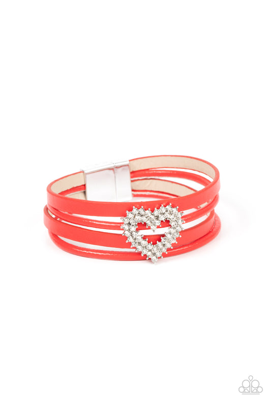 Paparazzi Accessories Wildly in Love - Red Featuring pronged silver fittings, two rows of glassy white rhinestones stack into a sparkly heart frame that is threaded along layers of red leather strands around the wrist. Features a magnetic closure. Sold as