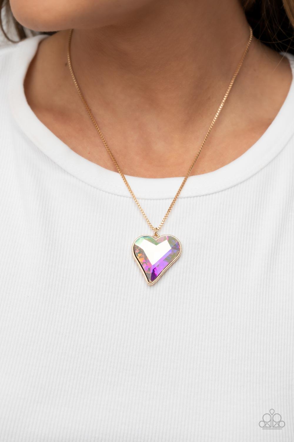Paparazzi Accessories Lockdown My Heart - Gold An iridescent heart-shaped gem is pressed into a simple gold frame at the end of a gold box chain creating an adorable sentiment below the collar. Features an adjustable clasp closure. Sold as one individual