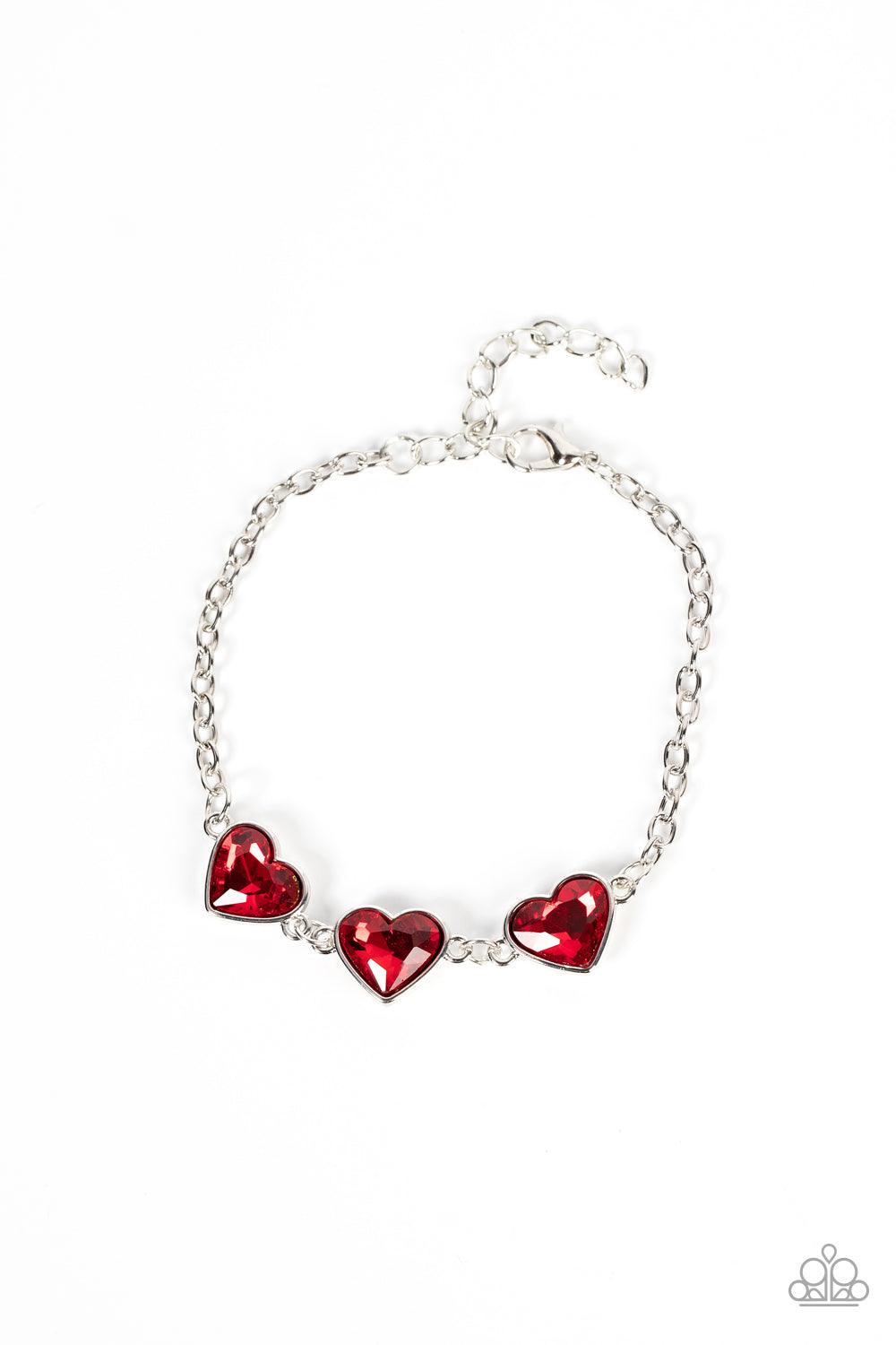 Paparazzi Accessories Little Heartbreaker - Red Nestled in silver frames, a trio of glittery red heart-shaped gems delicately links across the wrist for a dash of swoon-worthy shimmer. Features an adjustable clasp closure. Sold as one individual bracelet.