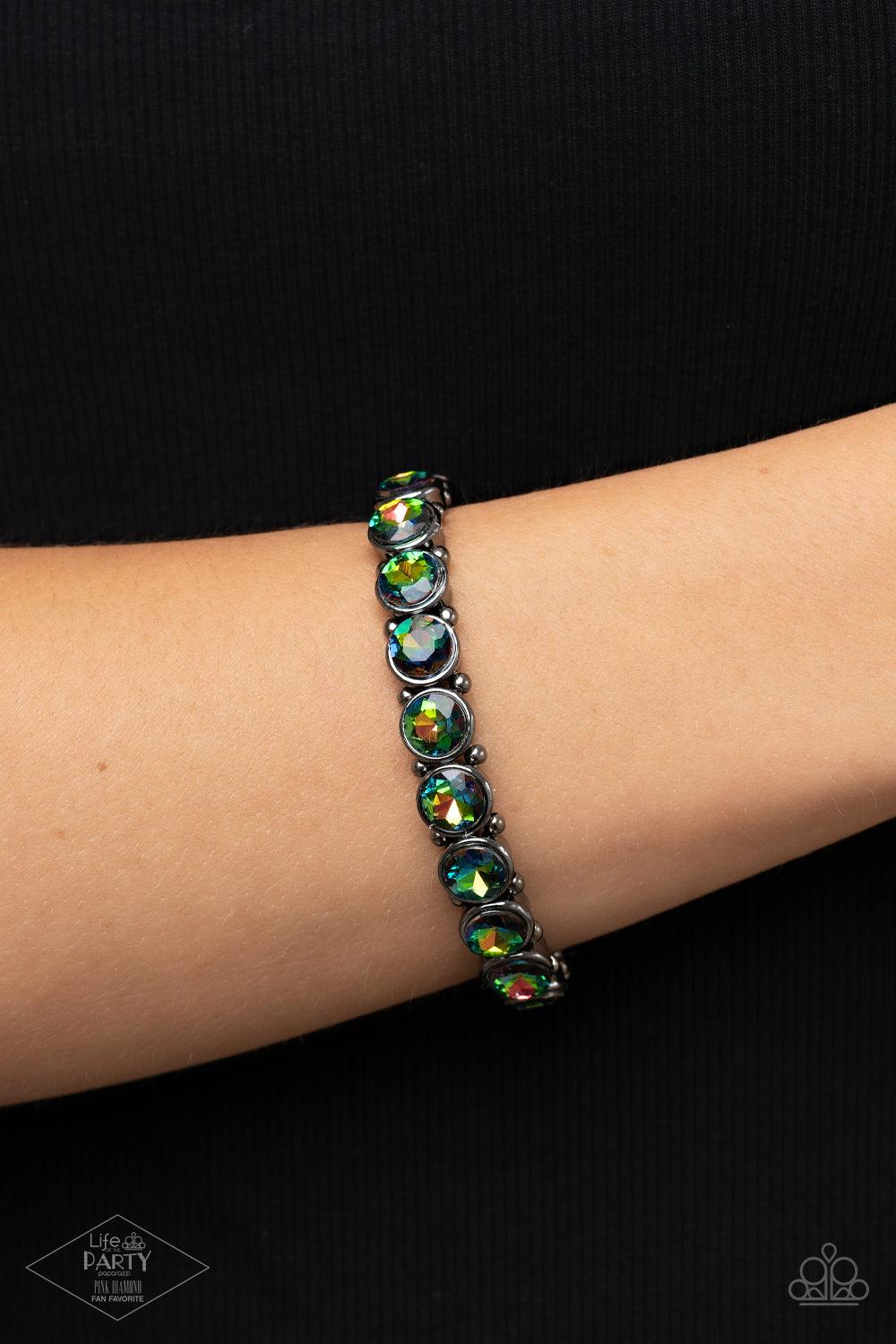 Paparazzi Accessories Sugar-Coated Sparkle - Multi 2 Infused with dainty gunmetal beads, glittery oil spill rhinestone encrusted frames are threaded along stretchy bands around the wrist for a glamorous look. Sold as one individual bracelet. Jewelry