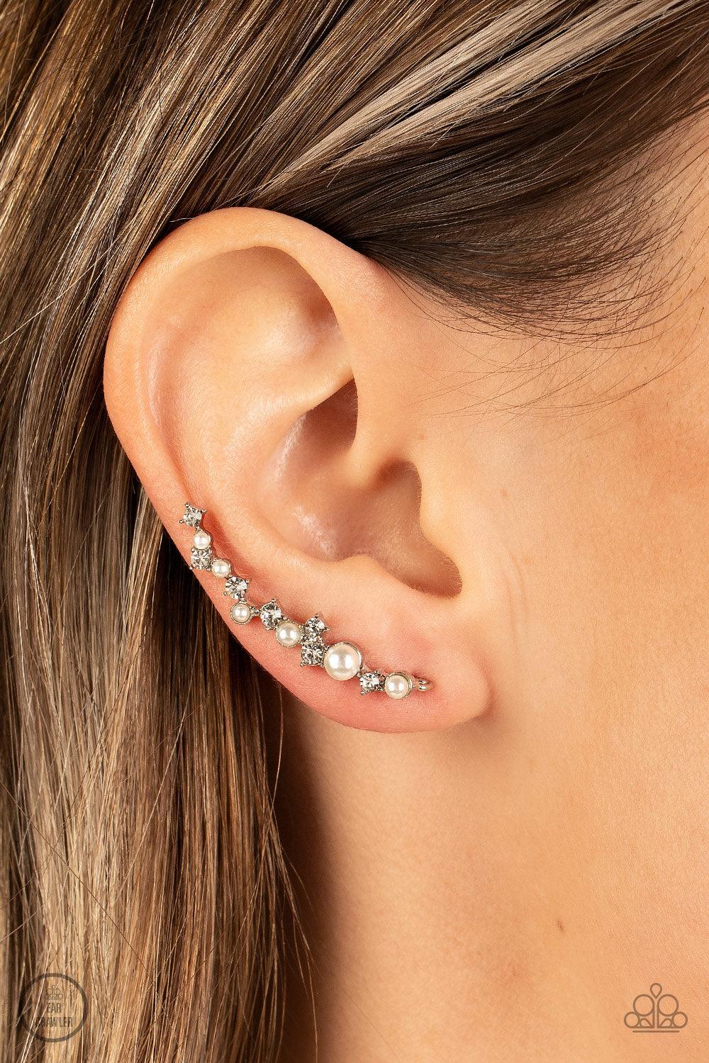 Paparazzi Accessories Couture Crawl - White A bubbly assortment of dainty white rhinestones and white pearls gently climbs the ear for a timeless fashion statement. Features an extended post fitting that climbs the back of the ear and can be pressed toget