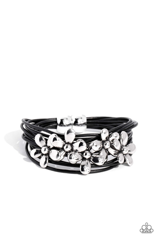 Paparazzi Accessories Here Comes the BLOOM - Black Shiny silver flowers glide along leathery black cords, clustering into a shimmery floral statement piece at the center of the wrist. Features a magnetic closure. Sold as one individual bracelet. Jewelry
