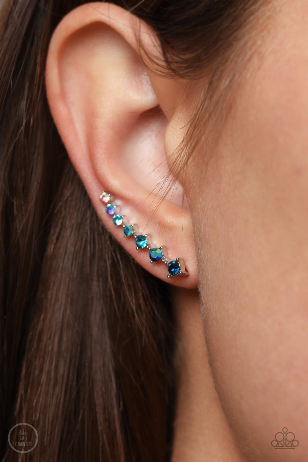 Paparazzi Accessories STARLIGHT Show - Blue An iridescent spectrum of dainty blue rhinestones gradually increase in intensity as they climb the ear for a stellar fashion. Features an extended post fitting that climbs the back of the ear and can be pressed