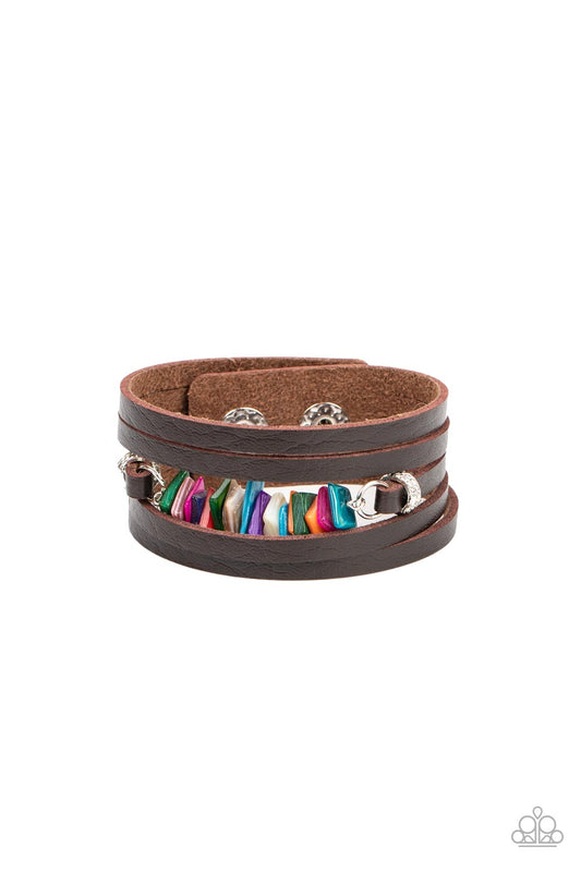 Paparazzi Accessories Tropical Trek - Multi A brown leather band is spliced into rugged layers around the wrist. Infused with textured silver rings, the centermost strand is infused with a stack of multicolored shell-like accents for a tropical inspired f