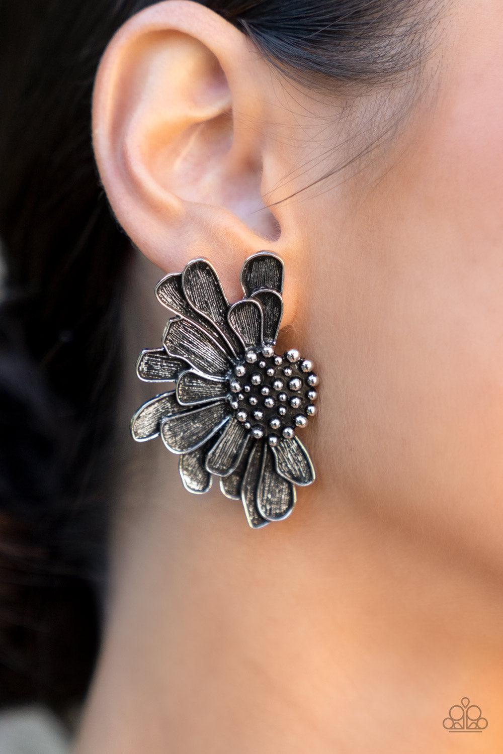 Paparazzi Accessories Farmstead Meadow - Silver Imperfect silver petals bloom from a studded center, layering into a rustic half blossom for a whimsical flair. Earring attaches to a standard post fitting. Sold as one pair of post earrings. Earrings