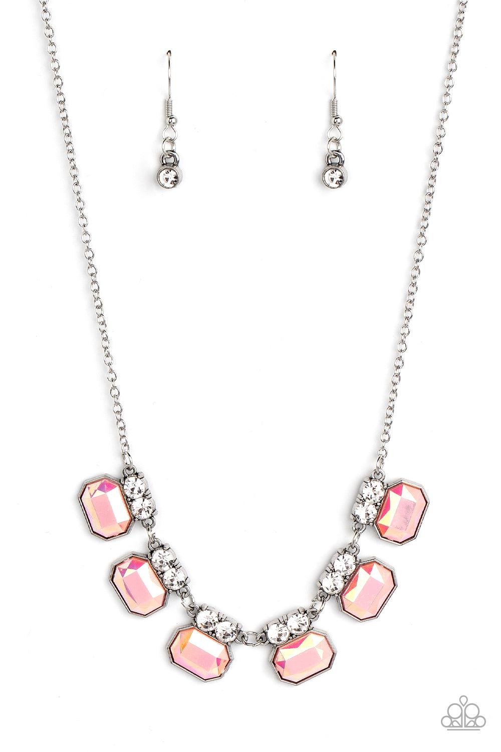 Paparazzi Accessories Interstellar Inspiration - Pink Featuring an iridescent UV finish, glitzy pink rhinestones are crowned in pairs of glassy white rhinestones as they delicately link below the collar for an out-of-this-world sparkle. Features an adjust