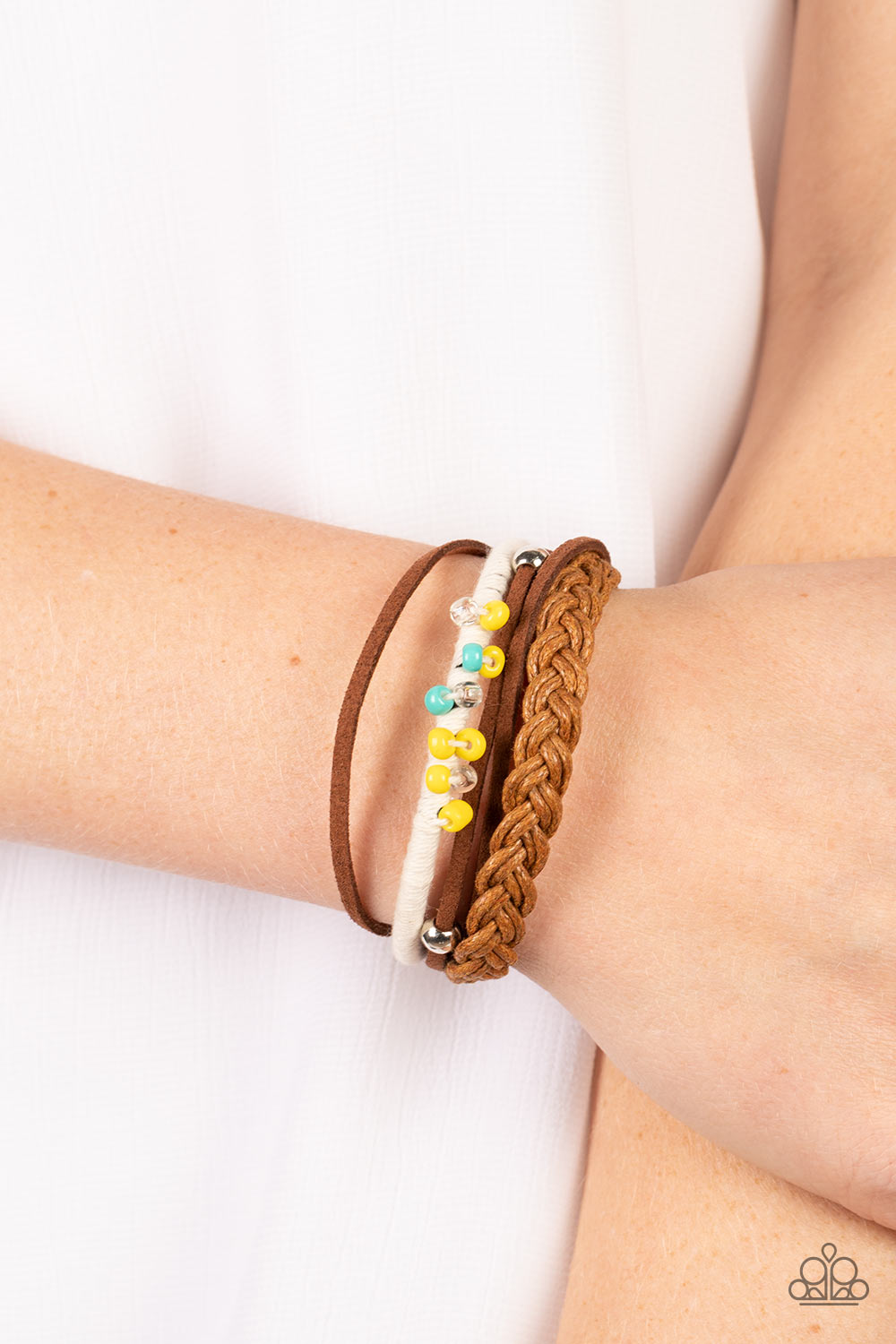 Paparazzi Accessories Summer Spectacle - Multi Infused with a pair of silver beads and rows of blue and yellow seed beads, mismatched suede, cord, and braided bands layer around the wrist for an adventurous vibe. Features an adjustable sliding knot closur