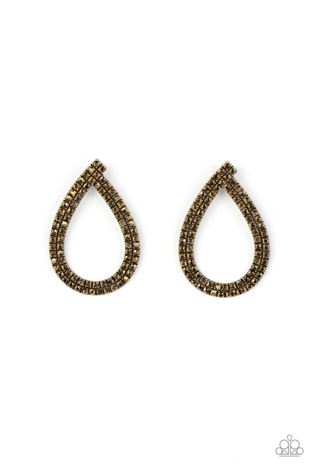Paparazzi Accessories Diva Dust - Brass Glitzy ribbons of dainty aurum rhinestones delicately swoop into a gritty teardrop frame, resulting in a sultry sparkle. Earring attaches to a standard post fitting. Sold as one pair of post earrings. Earrings