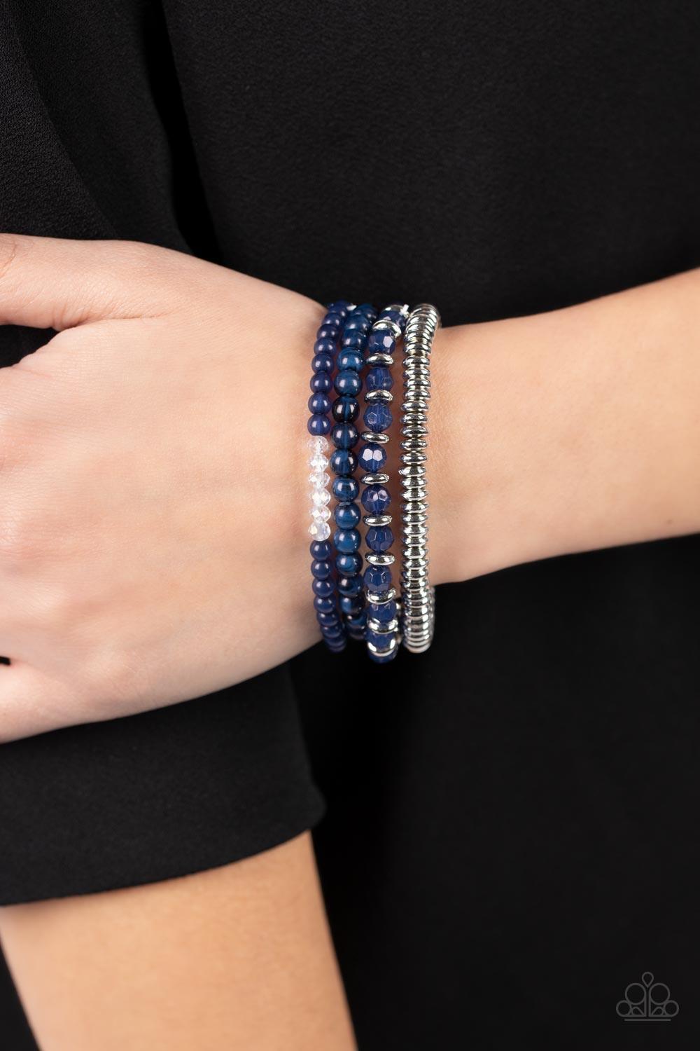 Paparazzi Accessories Destination Dreamscape - Blue A mismatched collection of opaque and crystal-like navy blue beads intermix with silver accents and white crystal-like beads along stretchy bands around the wrist, creating colorful layers. Sold as one s