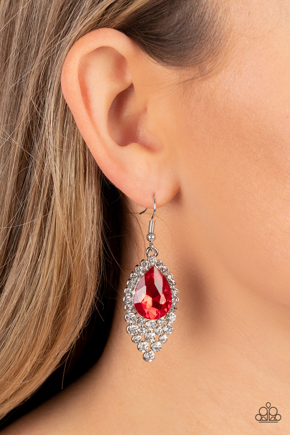 Paparazzi Accessories Glorious Glimmer - Red An oversized red teardrop gem is pressed into a glittering backdrop of glassy white rhinestones, cascading into an elegant effervescence. Earring attaches to a standard fishhook fitting. Sold as one pair of ear