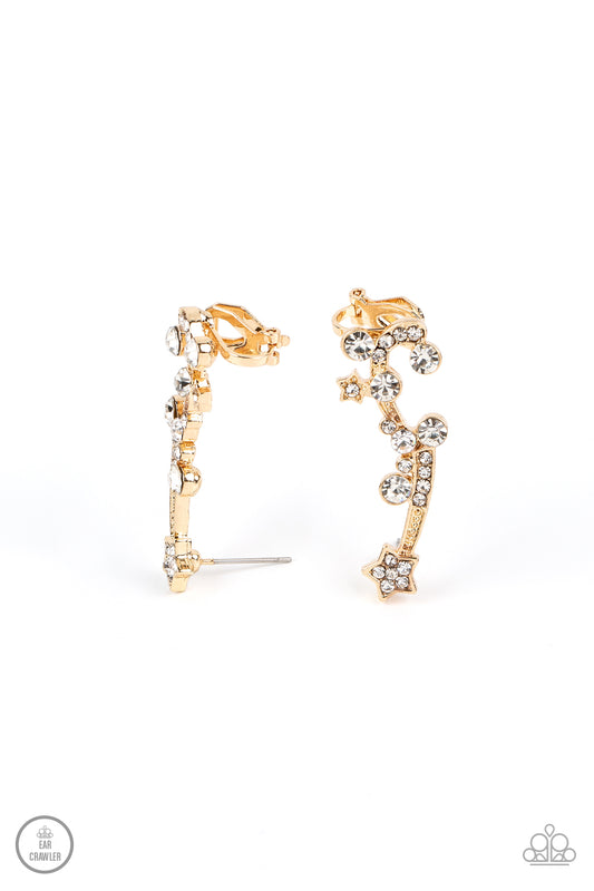 Paparazzi Accessories Astral Anthem - Gold Dotted with dainty gold studs, glittery white rhinestones, a white rhinestone dotted star, and a glittery ribbon streams out from a white rhinestone dotted gold star like a shooting star as it climbs the ear. Ear