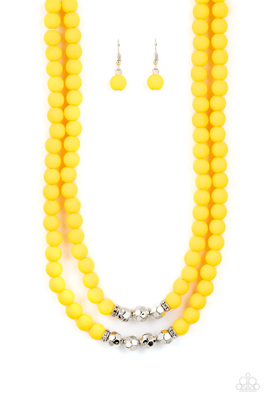 Paparazzi Accessories Summer Splash - Yellow Threaded along invisible wires, matte-finished Daffodil beads give way to center sections of white rhinestone encrusted rings and faceted silver beads. The sunny display layers below the collar, creating a summ