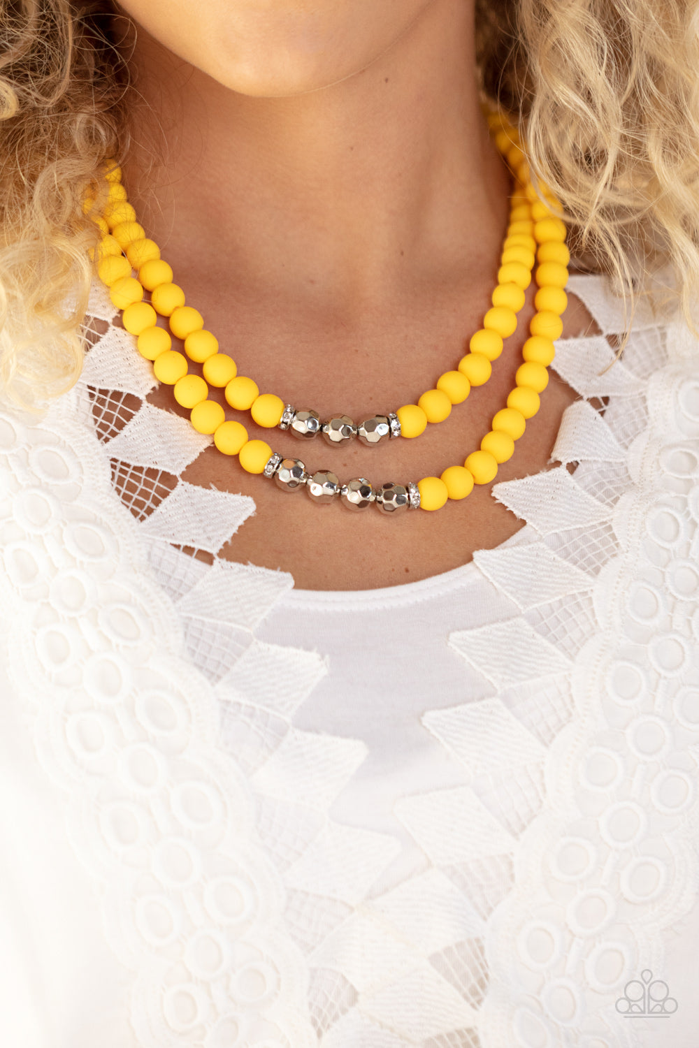 Paparazzi Accessories Summer Splash - Yellow Threaded along invisible wires, matte-finished Daffodil beads give way to center sections of white rhinestone encrusted rings and faceted silver beads. The sunny display layers below the collar, creating a summ