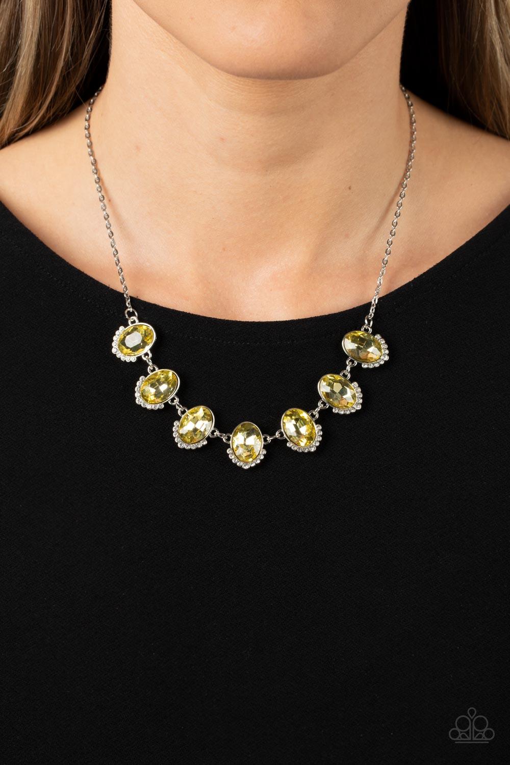 Paparazzi Accessories Unleash Your Sparkle - Yellow Dainty rows of glittery white rhinestones gently curve around the bottoms of oversized Daffodil oval gems. The sparkly frames delicately connect below the collar, creating a colorful centerpiece. Feature