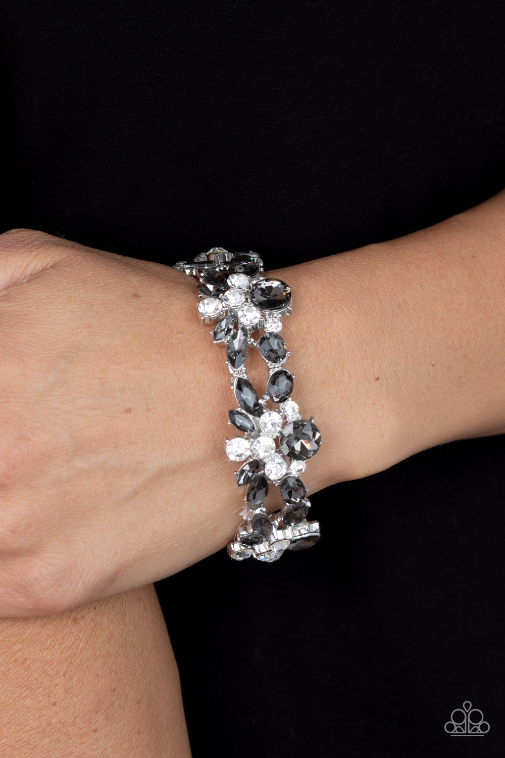 Paparazzi Accessories Beloved Bling - Silver Crowned with a smoky rhinestone, stacks of classic white and smoky marquise cut rhinestones coalesce into scintillating clusters. The glassy clusters are threaded along stretchy bands creating a dazzling displa