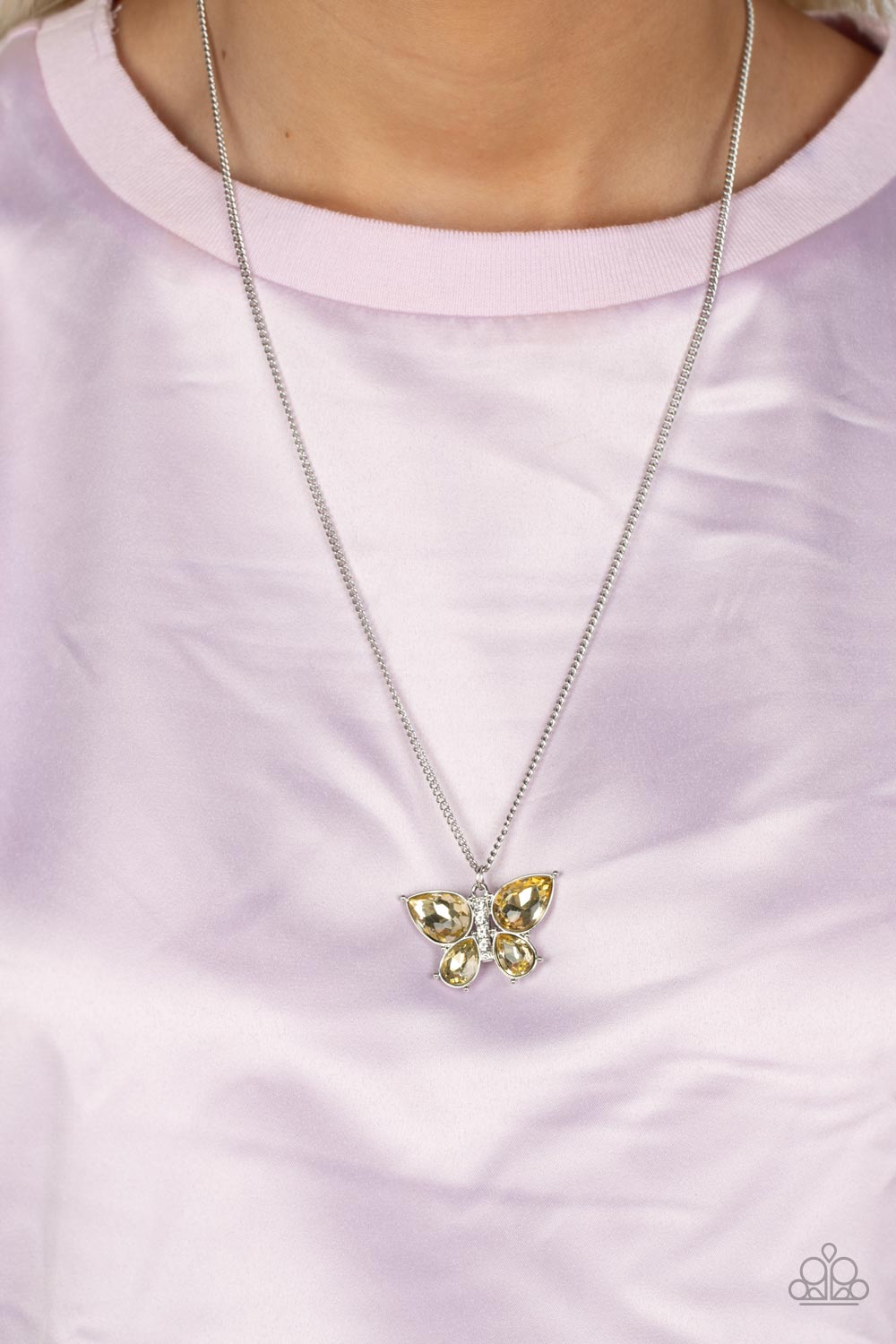 Paparazzi Accessories Free-Flying Flutter - Yellow A silver butterfly with yellow teardrop rhinestone wings and a white-rhinestone body delicately flutters at the bottom of a silver chain. Features an adjustable clasp closure. Sold as one individual neckl