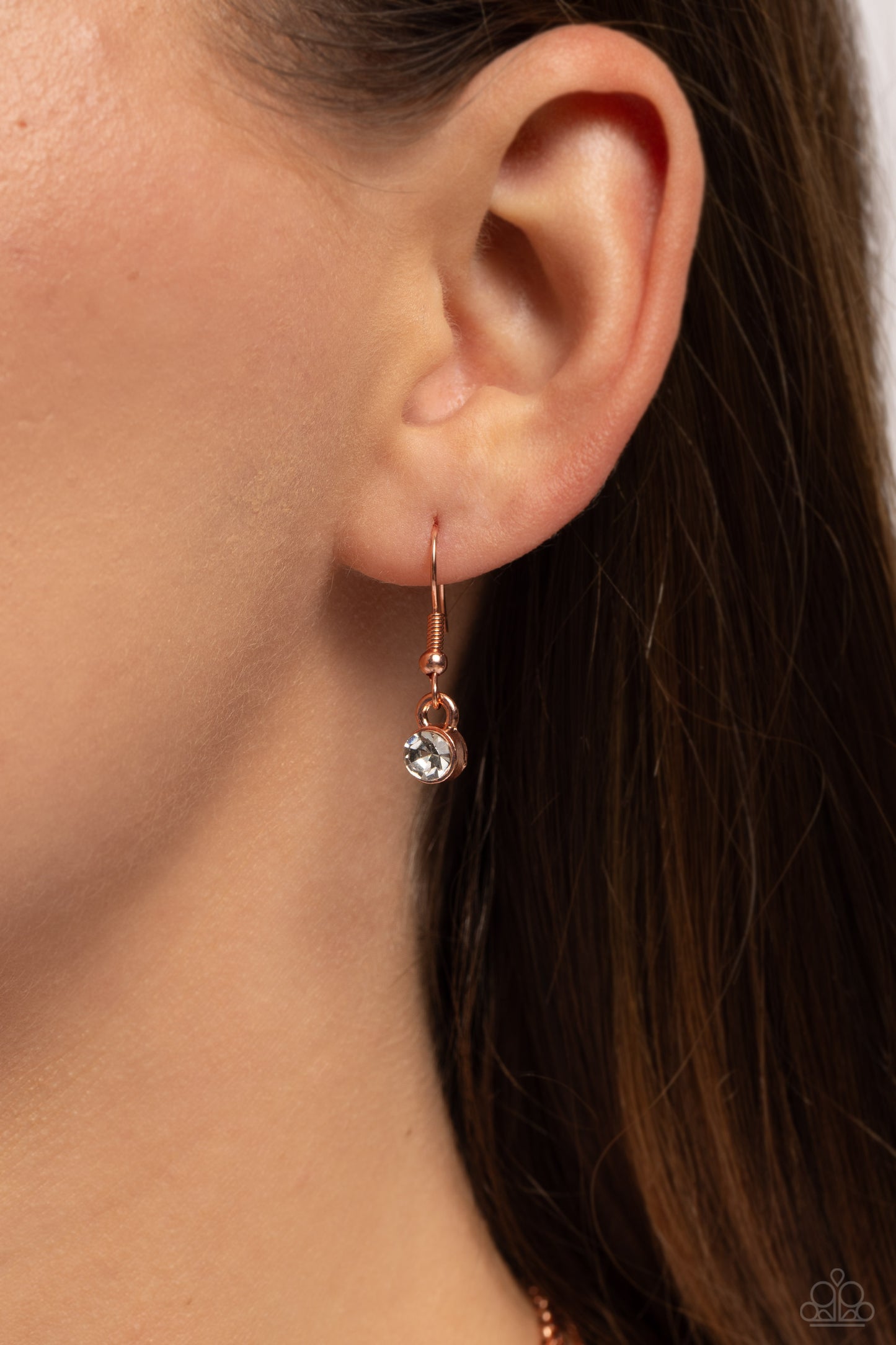 Paparazzi Accessories Trendy Twinkle - Copper Three mismatched shiny copper chains layer across the chest. Dotted in a dainty white rhinestone, a shiny copper charm swings from the uppermost chain above a solitaire white rhinestone for a twinkly finish. F