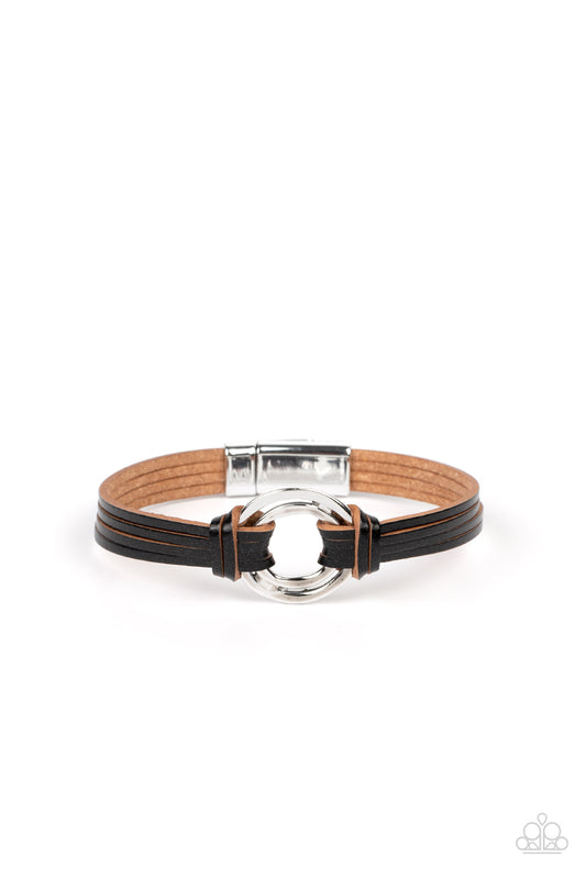 Paparazzi Accessories Free Range Fashion - Black Black leather strips knot around a soldered pair of asymmetrical hoops, knotting the rustic frame in place at the center of the wrist for a free-spirited finish. Features a magnetic closure. Sold as one ind