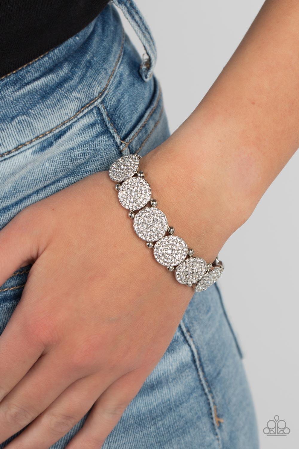 Paparazzi Accessories Palace Intrigue - White Separated by pairs of silver beads, glassy white rhinestone encrusted silver frames glitter along stretchy bands around the wrist for an out-of-this-world sparkle. Sold as one individual bracelet. Jewelry