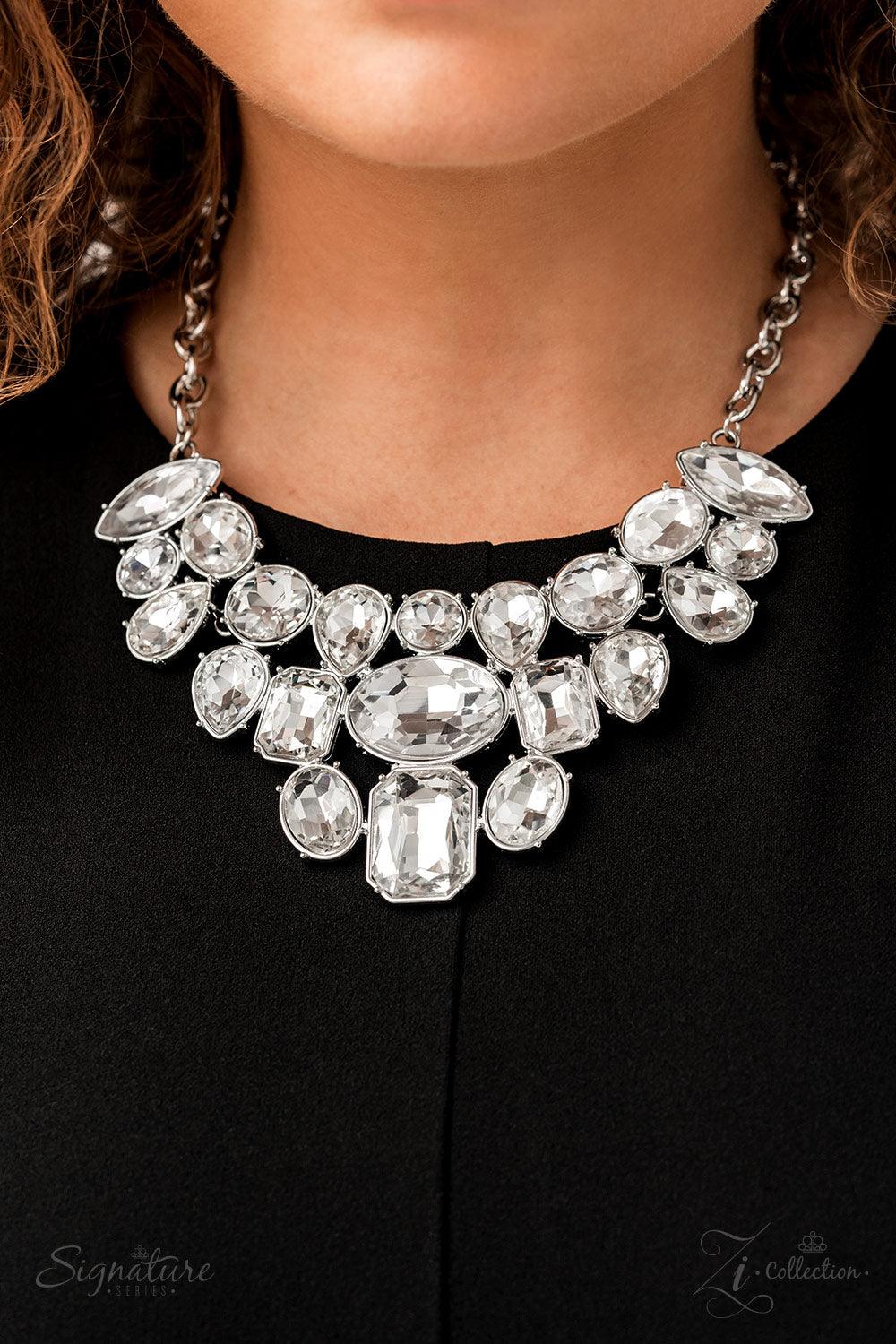 Paparazzi Accessories The Tasha Encased in pronged silver frames, a collection of oversized marquise, round, oval, emerald, and teardrop shaped white gems blindingly coalesces into a jaw-dropping statement piece below the collar. At the center of the coll