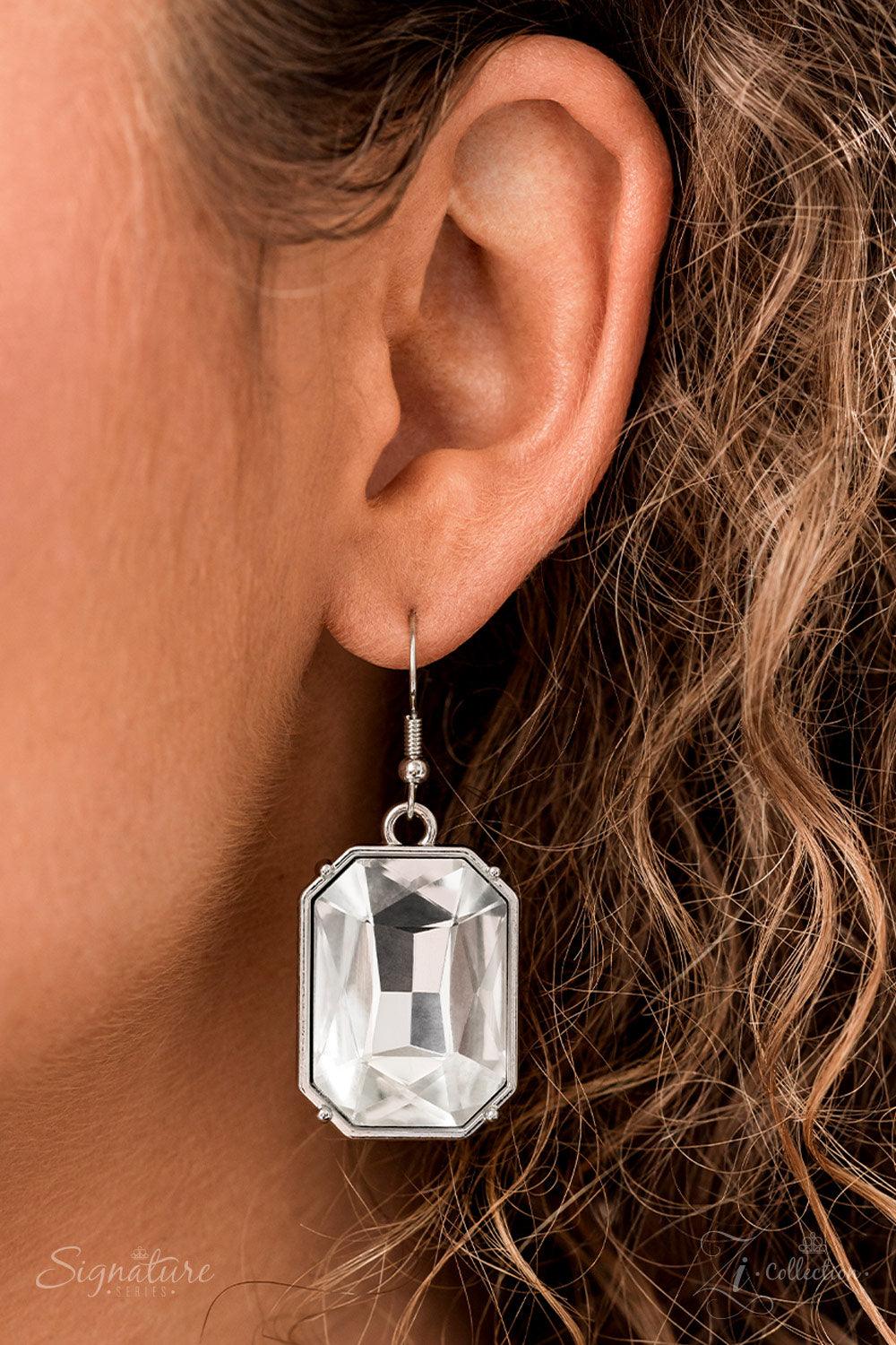 Paparazzi Accessories The Tasha Encased in pronged silver frames, a collection of oversized marquise, round, oval, emerald, and teardrop shaped white gems blindingly coalesces into a jaw-dropping statement piece below the collar. At the center of the coll