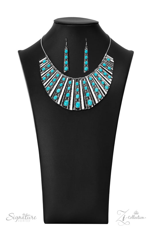 Paparazzi Accessories The Ebony Elongated silver plates featuring a high sheen finish fan out unapologetically along the collar, graduating in size as they lead down to the center. Oval-shaped turquoise stones, nestled in raised silver borders, adorn ever