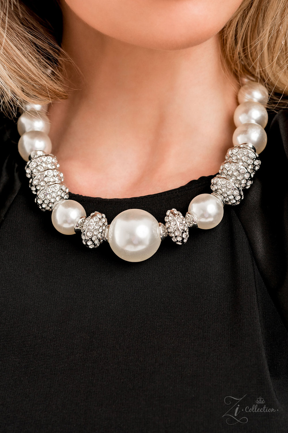 Paparazzi Accessories Noble Exaggerated white pearls gradually increase in size as they fall along the neckline, leading to a prominent centerpiece. The refined palette is complemented by shimmery silver accents, interspersed throughout the polished pearl
