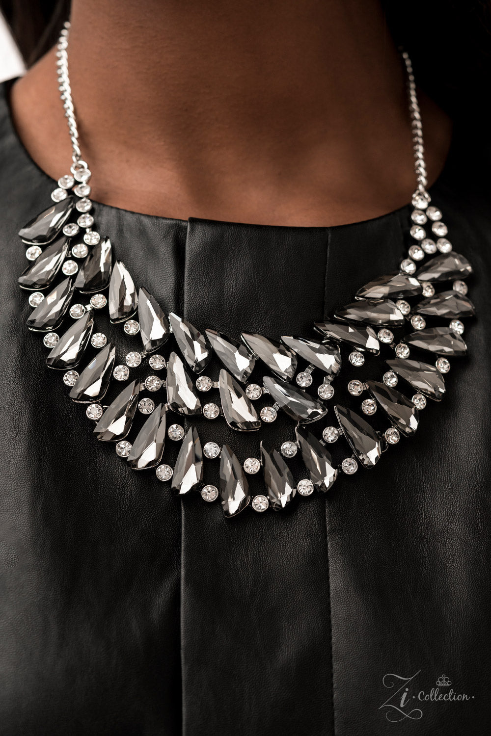 Paparazzi Accessories Perceptive Smoky, triangular rhinestones are scattered along the collar in razor-sharp precision, falling into a dramatic, angular pattern. Brilliant white rhinestones are sprinkled in between the faceted, smoldering gems, adding fea
