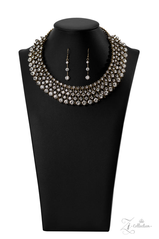Paparazzi Accessories Undeniable Thin bars of brass, etched in rugged linear texture and dotted with tiny brass studs, are topped by brilliant white rhinestones encased in pronged fittings. The bars are threaded along wires and separated by tiny brass bea