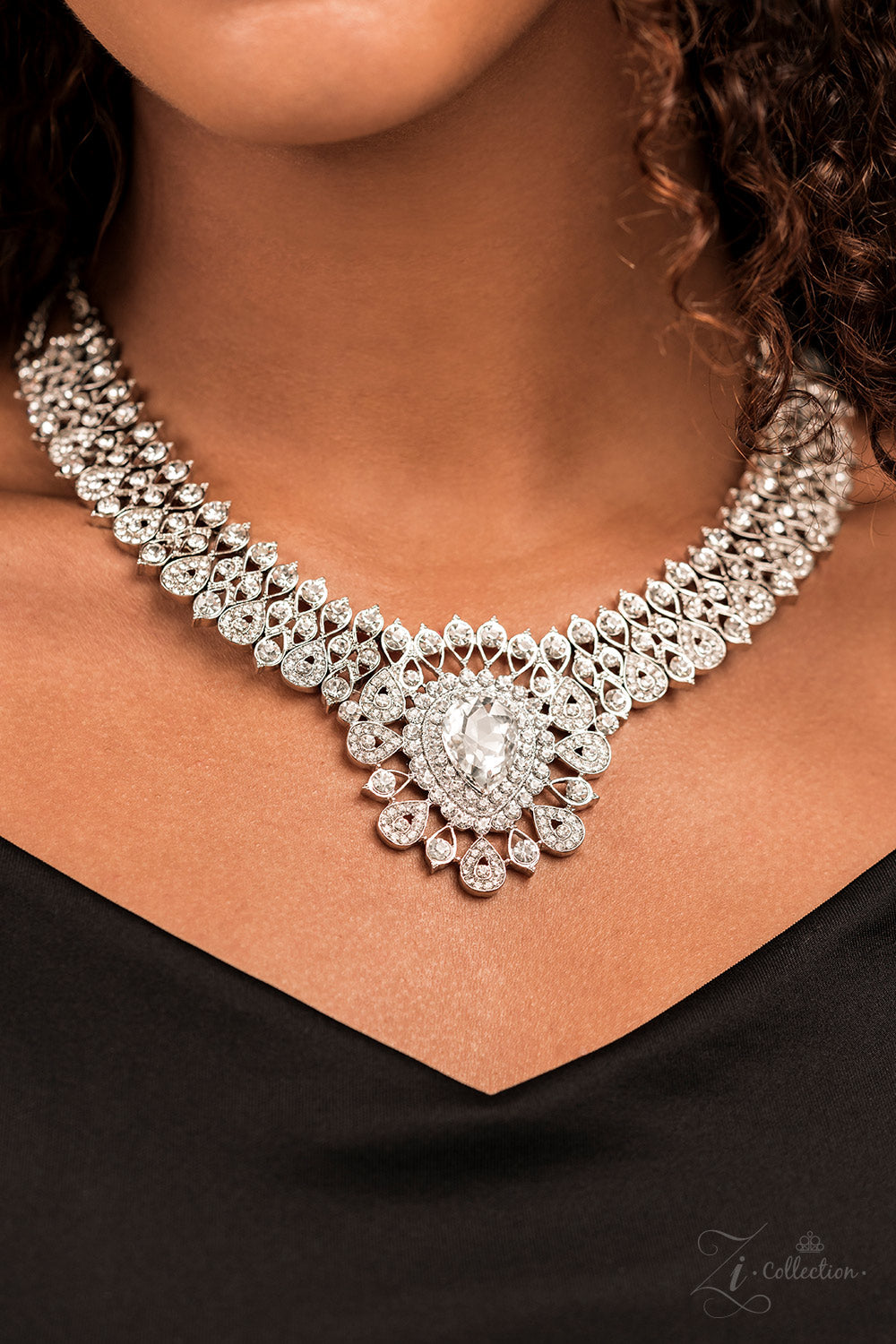 Paparazzi Accessories Exquisite Silver, teardrop-shaped frames are stacked on-point below airy marquise cutouts, creating a subtle figure-eight. The hourglass shapes are threaded along invisible wires, falling into place alongside diamond-shaped frames, c