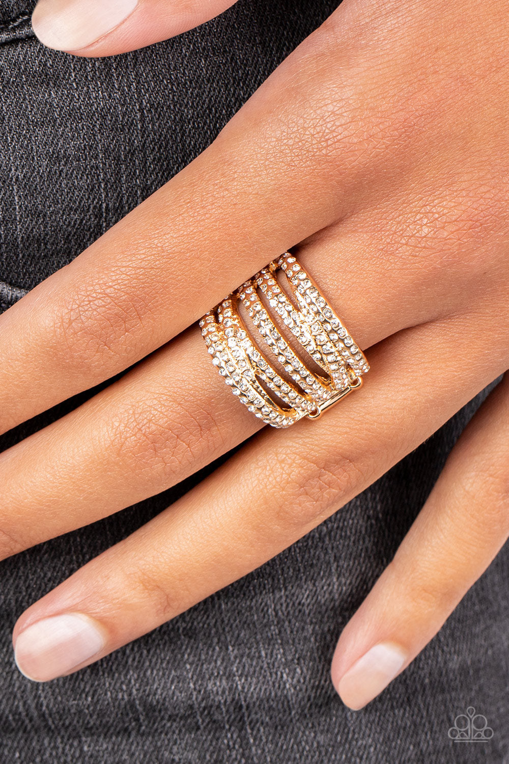 Paparazzi Accessories Knock-Out Opulence - Gold Encrusted in dainty pairs of blinding white rhinestones, row after row of glitzy gold bands stack and crisscross across the finger for a knockout look. Features a stretchy band for a flexible fit. Sold as on
