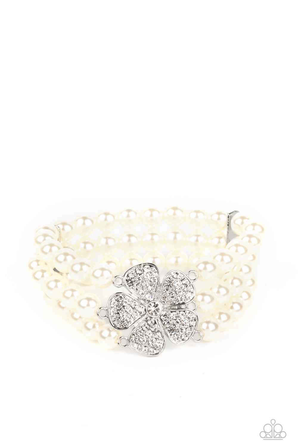 Paparazzi Accessories Park Avenue Orchard - White Separated by dainty silver plates, classic white pearls are threaded along three stretchy bands around the wrist. Encrusted in glassy white rhinestones, a glitzy silver flower blooms at the center of the w