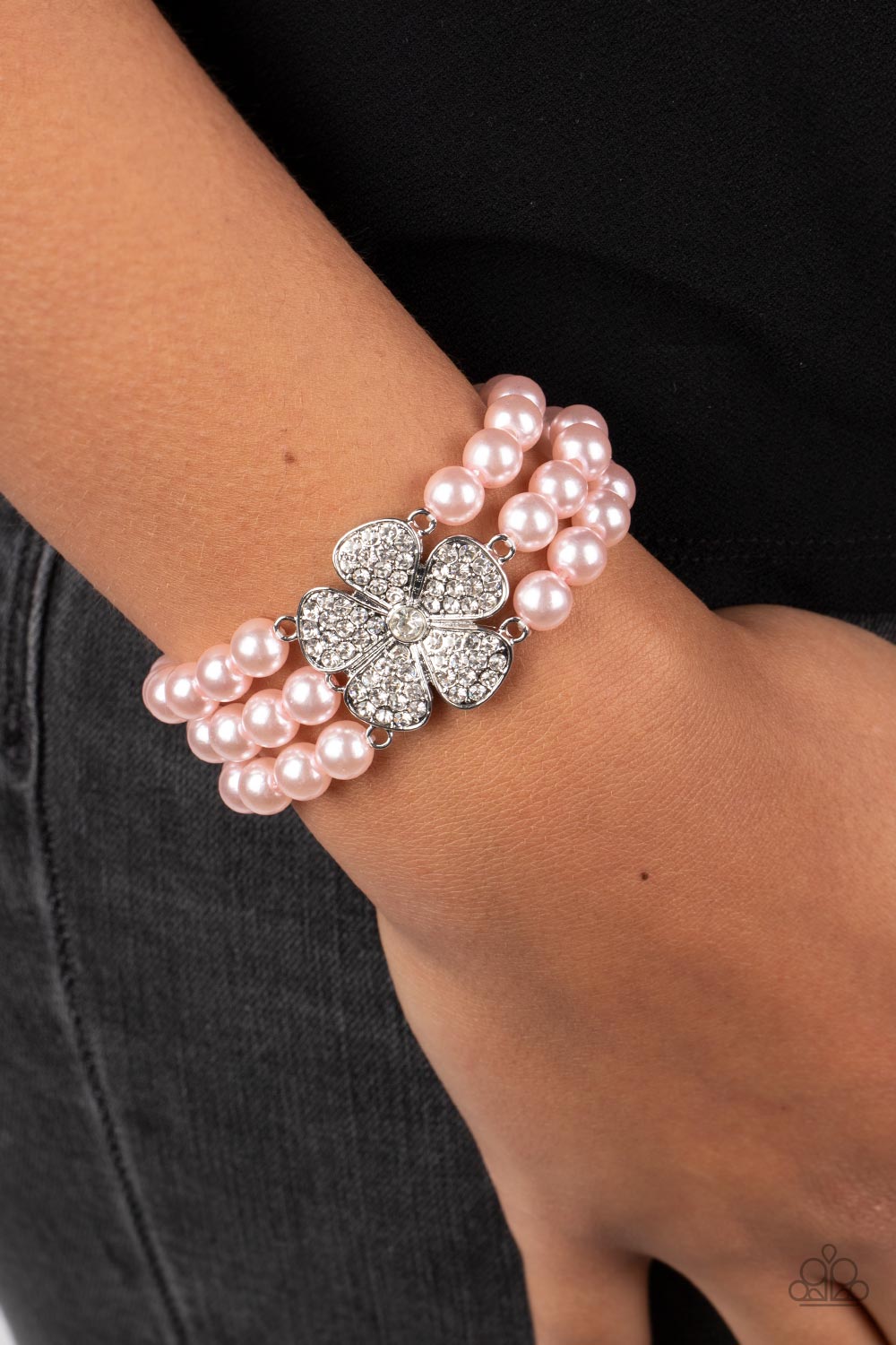 Paparazzi Accessories Park Avenue Orchard - Pink Separated by dainty silver plates, bubbly pink pearls are threaded along three stretchy bands around the wrist. Encrusted in glassy white rhinestones, a glitzy silver flower blooms at the center of the wris