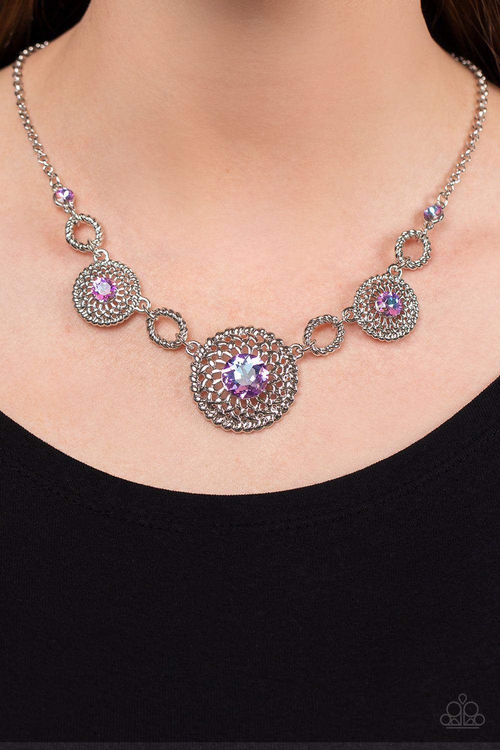 Paparazzi Accessories Cosmic Cosmos - Purple Airy silver petals delicately bloom inside twisted silver hoops below the collar. Dotted with iridescent purple rhinestone centers, the flowery frames gradually increase in size as they link with twisted silver