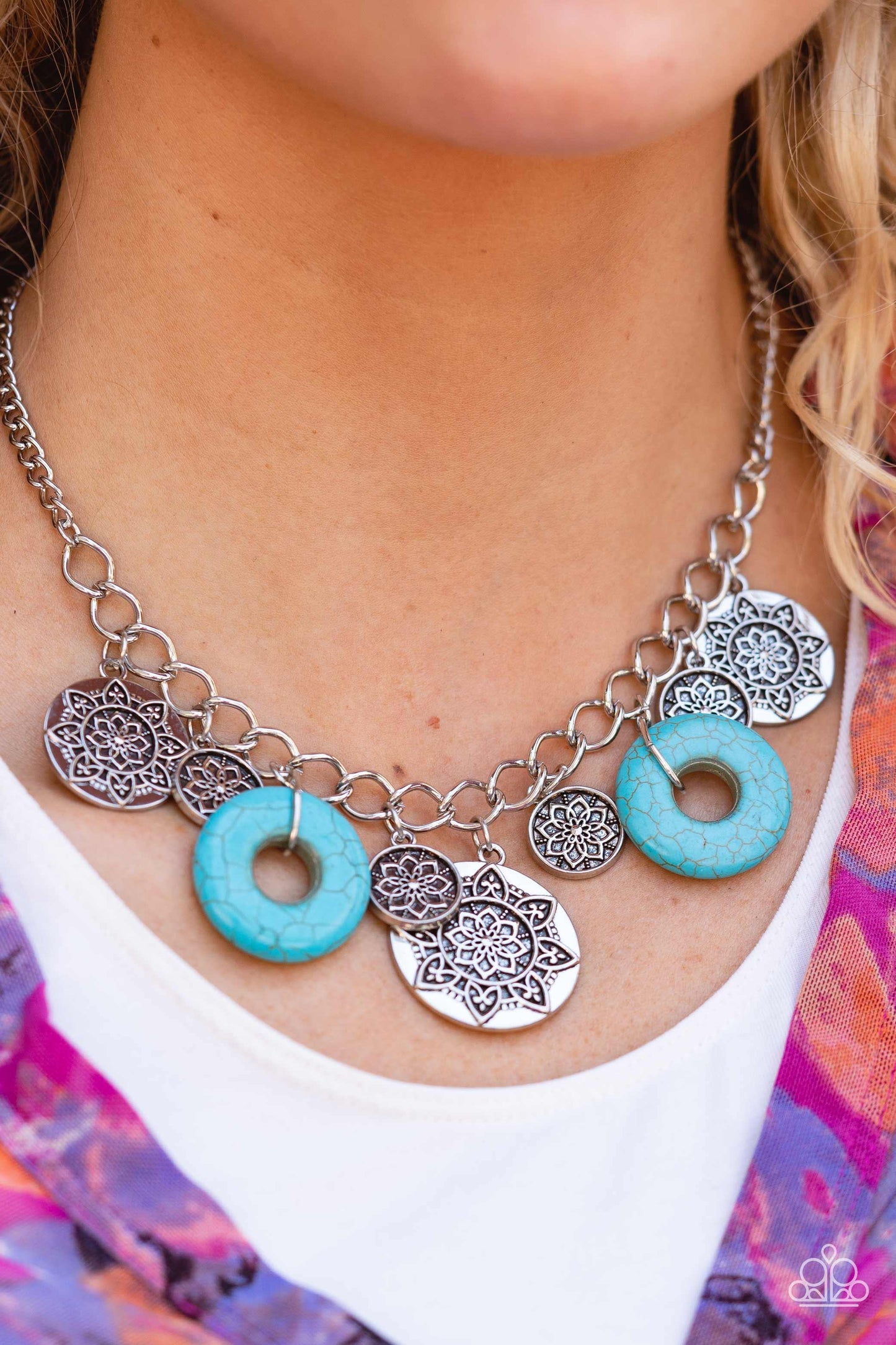 Paparazzi Accessories Western Zen - Blue A collection of silver discs, embellished with intricate mandala-like designs, dances along a thick silver chain, with a pair of polished turquoise stone rings adding a pop of color to the rustic design. Features a