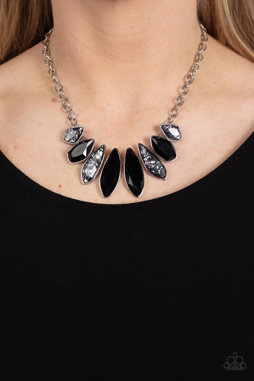 Paparazzi Accessories Crystallized Couture - Black A thick silver chain gives way to a collection of edgy silver frames that fall in line along the collar. The asymmetrical frames are emphasized by the alternating gems inside them, resulting in a gorgeous