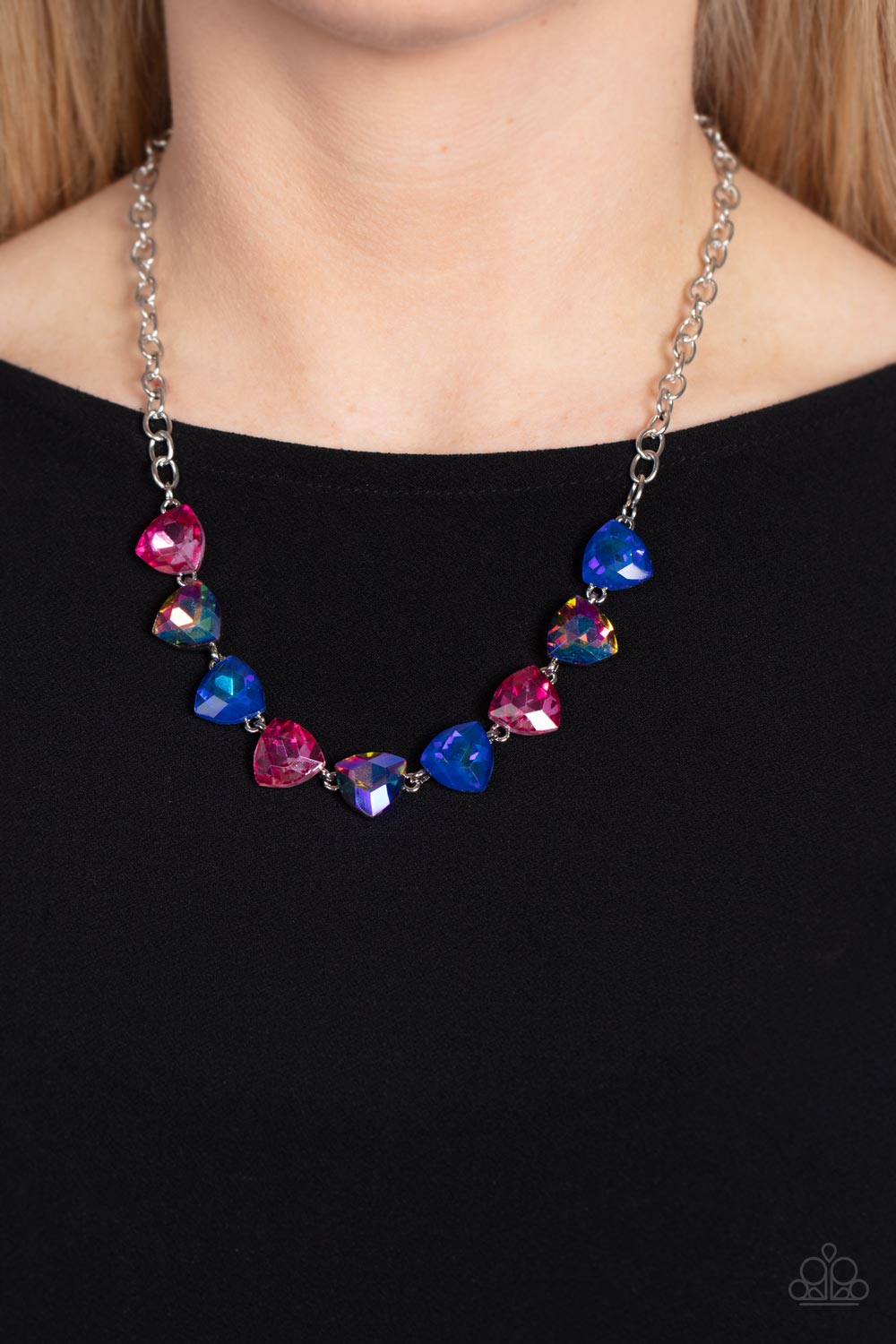 Paparazzi Accessories Dreamy Drama - Blue A collection of dreamy trilliant-cut rhinestones in iridescent shades of blue and pink fall in line along the collar in a majestic finish. Features an adjustable clasp closure. Due to its prismatic palette, color