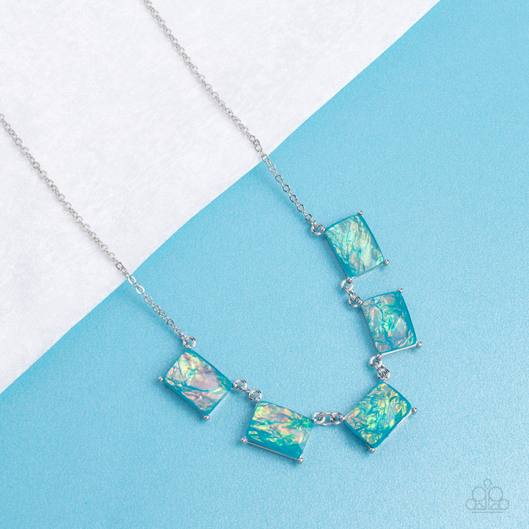 Paparazzi Accessories Opalescent Oblivion - Blue Featuring a refracted shimmer and an opalescent finish, a collection of emerald-cut, glassy blue gems link along the collar to create a hypnotic pop of color. Each gem is pressed into a silver frame with pr