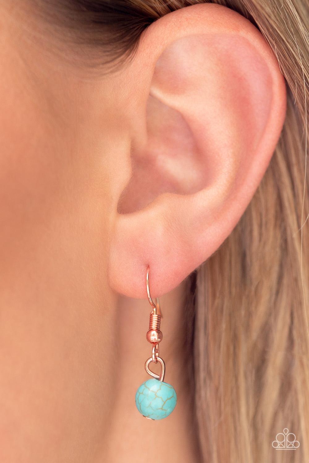 Paparazzi Accessories Sahara Sea - Copper Dangling from a shiny copper chain, an asymmetrical white shell with an opal finish is encircled by a turquoise stone-studded frame, creating a seasonal Southwestern pattern. As the stone elements in this piece ar