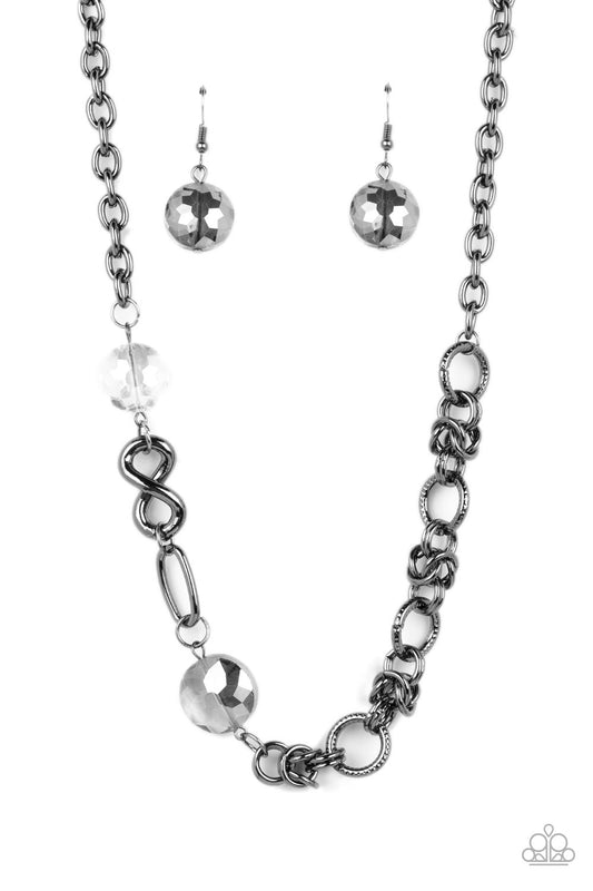 Paparazzi Accessories Celestially Celtic - Black Thick links of gunmetal twist into Celtic knot-like details, linking together with textured gunmetal hoops along the collar. A pair of faceted, saucer-shaped crystal beads, dipped in a reflective black diam