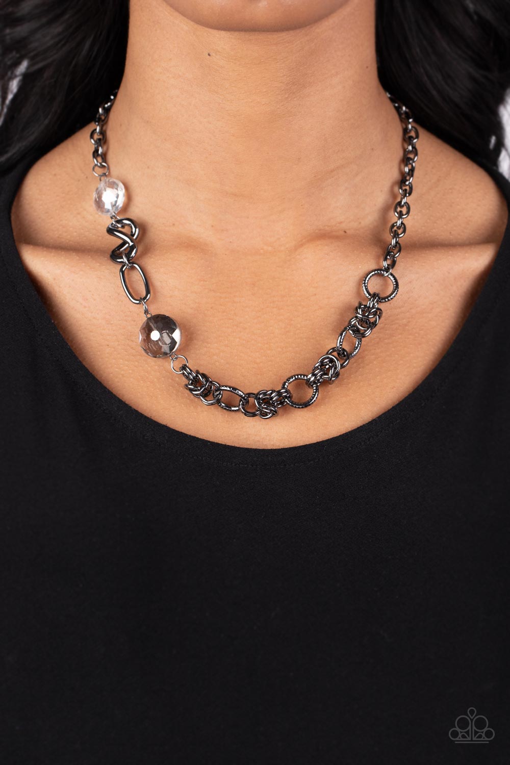 Paparazzi Accessories Celestially Celtic - Black Thick links of gunmetal twist into Celtic knot-like details, linking together with textured gunmetal hoops along the collar. A pair of faceted, saucer-shaped crystal beads, dipped in a reflective black diam