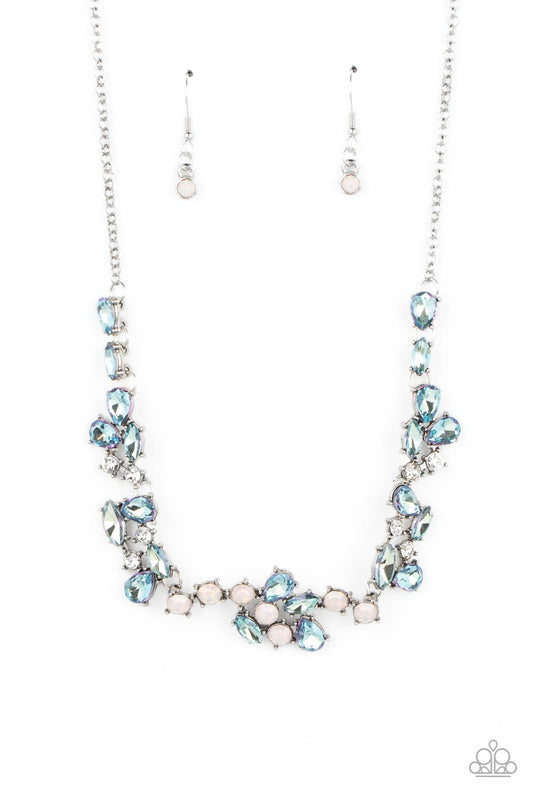 Paparazzi Accessories Welcome to the Ice Age - Blue Reflective frosty blue gems, white rhinestones, and gems with an opalescent finish gather together in a variety of inspired shapes into scattered clusters that connect across the collar. The edgy teardro