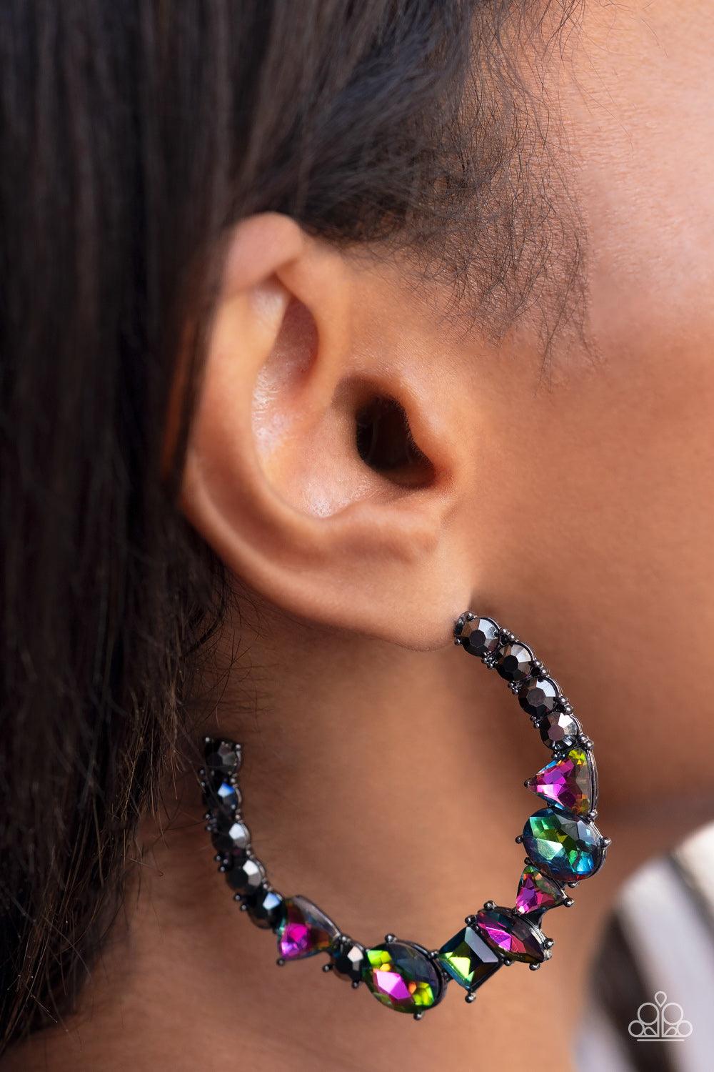 Paparazzi Accessories New Age Nostalgia - Multi Flanked by hematite rhinestones, a collection of geometric rhinestones with an oil-spill finish sleekly curve around the ear, creating a trendy, yet nostalgic display. Due to its prismatic palette, color may