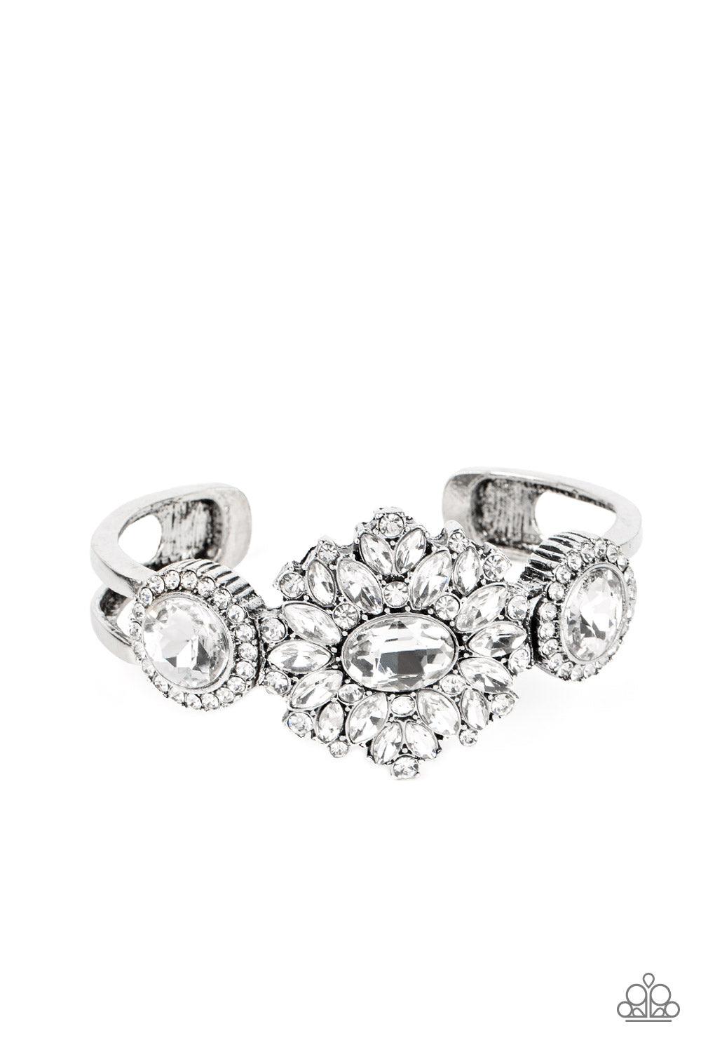 Paparazzi Accessories Daydream Dazzle - White A decadent explosion of dainty white rhinestones and teardrop gems frame a reflective oval gem at their center. On either side of the shimmery centerpiece dainty white rhinestones encircle reflective white gem