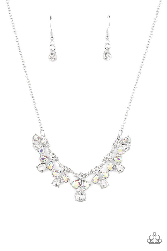 Paparazzi Accessories See in a New STARLIGHT - White Dainty white reflective gems, followed by a trio of iridescent and reflective teardrop gems vertically blaze down the collar, creating a starry shimmer. Due to its prismatic palette, color may vary. Fea